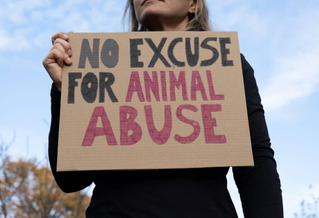 do i have to spay or neuter my esa under the fair housing act 1 - certapet - emotional support animal letters woman with placard advocating for animal rights.