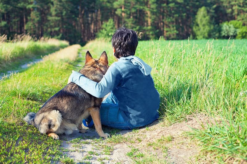 Guy with his dog in the countryside