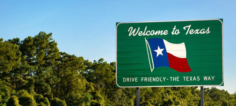 Welcome to Texas sign with blue skies.