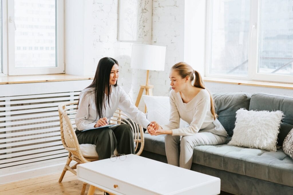 women having a discussion in a modern office.