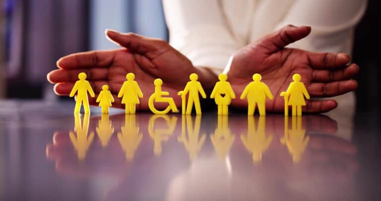 American Disability Act and Emotional Support Animal, ADA laws and protections for ESA. A person displaying figurines of stick figures with different disabilities positioned on a table with open hands.